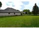 Spacious backyard with lush green lawn and wrought iron fence at 4723 Goldenrain Ct, Indianapolis, IN 46237