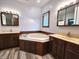 A gorgeous bathroom with dual vanities, a soaking tub, and updated fixtures at 4723 Goldenrain Ct, Indianapolis, IN 46237