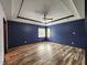 A spacious bedroom with unique ceiling trim, wood floors and bright natural light at 4723 Goldenrain Ct, Indianapolis, IN 46237