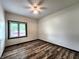 A bright bedroom with wood-look floors and a window overlooking the outdoor landscape creates a cozy at 4723 Goldenrain Ct, Indianapolis, IN 46237