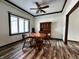 Bright dining room features wood floors, a ceiling fan, and a classic wooden table with chairs at 4723 Goldenrain Ct, Indianapolis, IN 46237