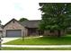 Charming brick home with a well-manicured lawn and mature trees, creating great curb appeal at 4723 Goldenrain Ct, Indianapolis, IN 46237