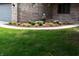 Well-maintained front yard featuring landscaped garden bed with fountain at 4723 Goldenrain Ct, Indianapolis, IN 46237