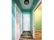 Hallway with neutral paint, wood-look floors, and white doors, offering practical and aesthetic appeal at 4723 Goldenrain Ct, Indianapolis, IN 46237