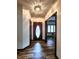 A light-filled hallway features a decorative front door and a glimpse into a dining area, showcasing design at 4723 Goldenrain Ct, Indianapolis, IN 46237