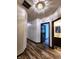 Hallway with wood-look floors and neutral paint, leading to various rooms in the house, and a bathroom at 4723 Goldenrain Ct, Indianapolis, IN 46237