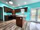 Modern kitchen with wood floors, an island, and stainless steel appliances, perfect for cooking and entertaining at 4723 Goldenrain Ct, Indianapolis, IN 46237