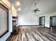 A spacious living room with fireplace, wood floors, ceiling fan and plenty of natural light at 4723 Goldenrain Ct, Indianapolis, IN 46237