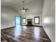 Cozy living room featuring a classic fireplace, wood floors and natural light from the surrounding windows at 4723 Goldenrain Ct, Indianapolis, IN 46237