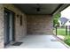 Large brick patio with ceiling fans, surrounded by a black fence and greenery, ideal for outdoor enjoyment at 4723 Goldenrain Ct, Indianapolis, IN 46237