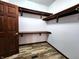 Organized walk-in closet with custom shelving and wooden floors at 4723 Goldenrain Ct, Indianapolis, IN 46237