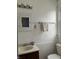 Bright bathroom with white tile, built in medicine cabinet, and classic fixtures at 48 N Audubon Rd, Indianapolis, IN 46219