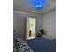 Primary bedroom with ensuite bathroom featuring a stylish blue ceiling fan at 48 N Audubon Rd, Indianapolis, IN 46219