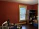 Comfortable bedroom with patriotic theme, natural light, and dark hardwood floors at 48 N Audubon Rd, Indianapolis, IN 46219