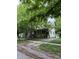 Charming two-story home with a classic design and covered front porch surrounded by mature trees at 48 N Audubon Rd, Indianapolis, IN 46219