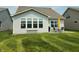 Well-kept backyard featuring lush green grass and a cozy patio set perfect for outdoor relaxation and entertaining at 4817 Allium Dr, Plainfield, IN 46168