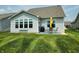 Outdoor patio with umbrella and seating overlooking the manicured lawn at 4817 Allium Dr, Plainfield, IN 46168