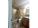 Bathroom with a glass-enclosed shower, vanity, and cabinet for storage at 4817 Allium Dr, Plainfield, IN 46168