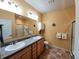 Bathroom featuring a double sink vanity, modern lighting fixtures, and a linen closet at 4817 Allium Dr, Plainfield, IN 46168