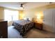 Comfortable bedroom with a patterned bed, ceiling fan, and plenty of natural light at 4817 Allium Dr, Plainfield, IN 46168