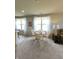 Bright dining area featuring large windows, a round table with seating, and elegant curtains at 4817 Allium Dr, Plainfield, IN 46168