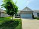 Lovely exterior with green lawn and mature tree showcasing the home's curb appeal and inviting atmosphere at 4817 Allium Dr, Plainfield, IN 46168