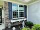 Charming exterior showcases a beautiful window box with flowers, enhancing curb appeal and inviting ambiance at 4817 Allium Dr, Plainfield, IN 46168