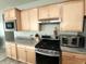Modern kitchen with wooden cabinets, stainless steel appliances, and gray counter tops at 4817 Allium Dr, Plainfield, IN 46168