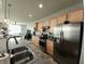 Modern kitchen featuring stainless steel appliances, center island, and seamless flow into the living area at 4817 Allium Dr, Plainfield, IN 46168