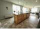 Functional kitchen island with sink, dishwasher, drawers, and open layout to the living spaces at 4817 Allium Dr, Plainfield, IN 46168