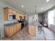 Well-lit kitchen with stainless steel appliances, center island with seating, and ample cabinet space at 4817 Allium Dr, Plainfield, IN 46168