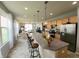 Open-concept kitchen with a large island, pendant lights, and stainless steel appliances seamlessly connected to living spaces at 4817 Allium Dr, Plainfield, IN 46168
