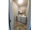 Functional laundry room with modern washer and dryer, and a shelving unit at 4817 Allium Dr, Plainfield, IN 46168