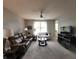 Bright living room showcasing plush seating, ceiling fan, large windows, and entertainment center at 4817 Allium Dr, Plainfield, IN 46168
