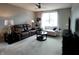 Inviting living room with a brown leather sofa, a white loveseat, and a round glass table at 4817 Allium Dr, Plainfield, IN 46168