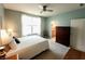 Inviting main bedroom with a cozy bed, soft lighting, and a doorway leading to the bathroom at 4817 Allium Dr, Plainfield, IN 46168