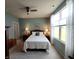 Comfortable main bedroom with a ceiling fan and large windows offering views of the yard at 4817 Allium Dr, Plainfield, IN 46168