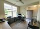 Well-lit home office boasts ample desk space, large windows, and an open view to the front entrance at 4817 Allium Dr, Plainfield, IN 46168