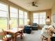 Bright sun room filled with natural light from many windows and adorned with a ceiling fan at 4817 Allium Dr, Plainfield, IN 46168