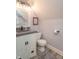 Bathroom featuring a modern vanity, toilet, and mirror, creating a clean and functional space at 505 Jones Pl, Martinsville, IN 46151