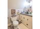 Stylish bathroom featuring modern fixtures, grey wood flooring, and sleek white cabinetry at 505 Jones Pl, Martinsville, IN 46151