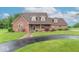 Charming brick home featuring a well-manicured lawn and a long, curved driveway at 505 Jones Pl, Martinsville, IN 46151