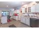 Bright eat-in kitchen featuring an island, stainless steel appliances, white cabinetry and granite countertops at 505 Jones Pl, Martinsville, IN 46151