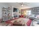 Bright living room with fireplace, large ceiling fan, modern decor, and lots of seating at 505 Jones Pl, Martinsville, IN 46151
