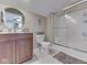 Bathroom with updated vanity, round mirror, and a glass-enclosed shower at 5351 Abbington Ave, Plainfield, IN 46168