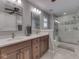 Bathroom with double vanity, a large mirror, and a glass-enclosed shower at 5351 Abbington Ave, Plainfield, IN 46168