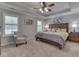 Spacious bedroom with trey ceiling, a ceiling fan, and two large windows with plantation shutters at 5351 Abbington Ave, Plainfield, IN 46168