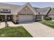Exterior view of a lovely single-Gathering home featuring a two-car garage, brick facade, and landscaped front yard at 5351 Abbington Ave, Plainfield, IN 46168