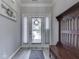 Bright foyer with a decorative wreath on the glass front door and hall tree at 5351 Abbington Ave, Plainfield, IN 46168
