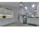 Kitchen featuring white cabinets, modern lighting, stainless steel appliances and an island with breakfast bar at 5351 Abbington Ave, Plainfield, IN 46168